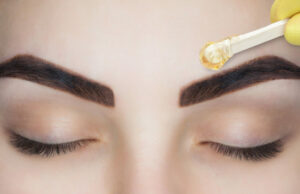 waxing a woman's eyebrows