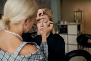 Beauty Business; Makeup artist applying makeup