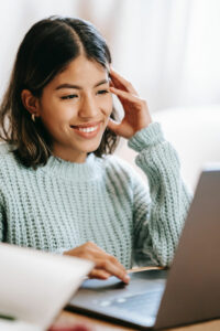 Woman smiling at her laptop