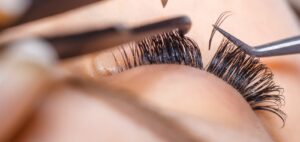 handmade fans being added to a person's eyelashes