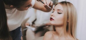 makeup artist doing a woman's makeup