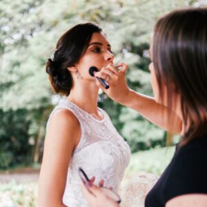 Woman having her bridal makeup done