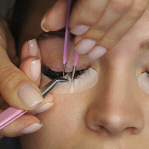 lash technician applying eyelash extensions