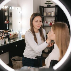 A makeup artist doing a client's makeup