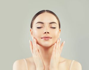 Woman applying facial treatments