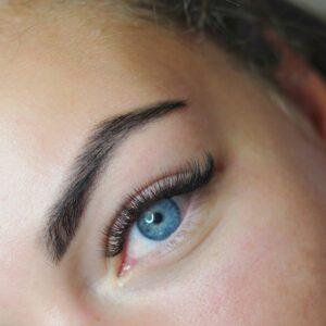 Close-up photo of fake eyelashes and a blue eye