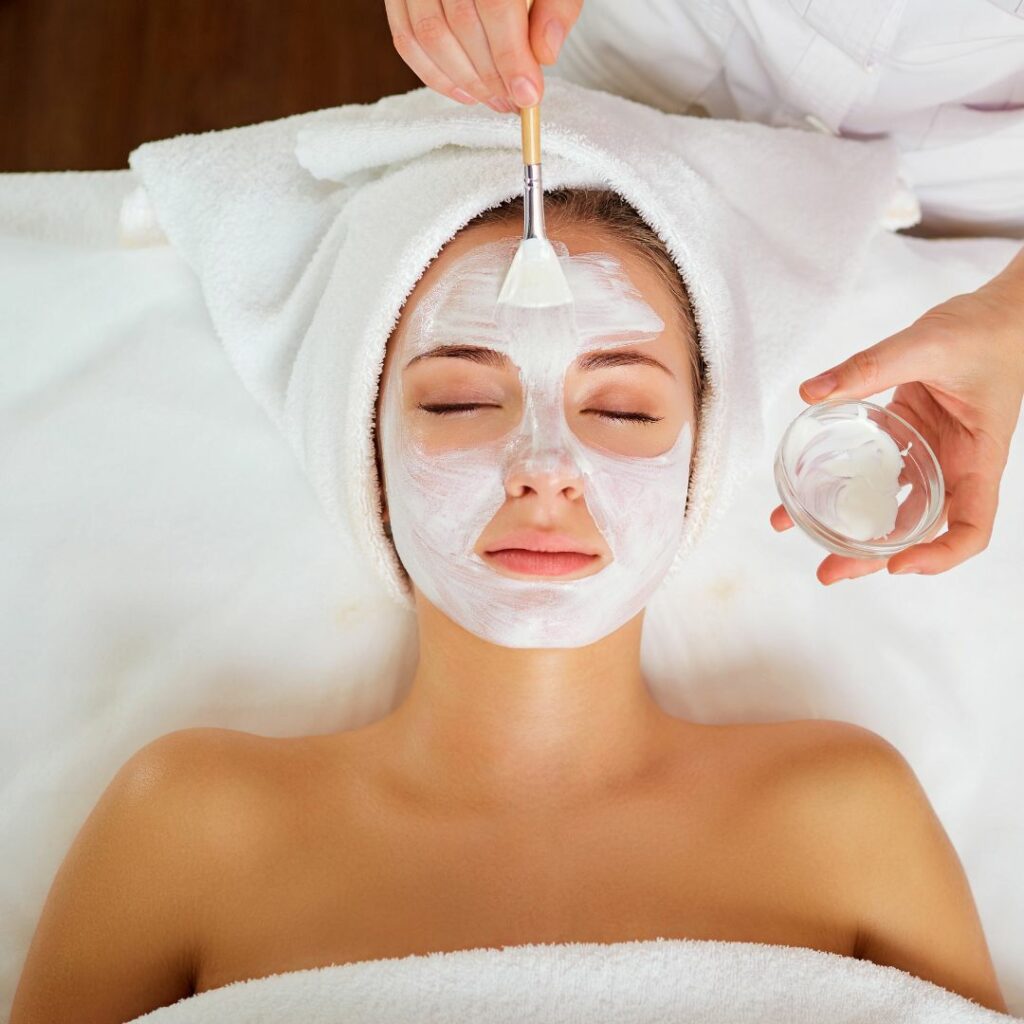 Woman having a facial mask applied
