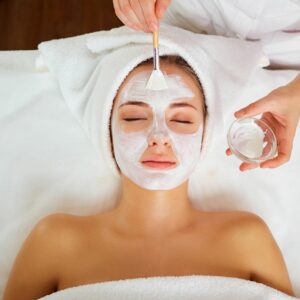 Woman having a facial mask applied