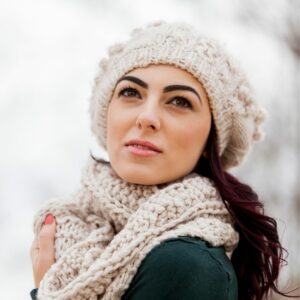 Girl wearing a scarf and beanie.