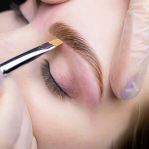 Eyebrow being marked with a brush