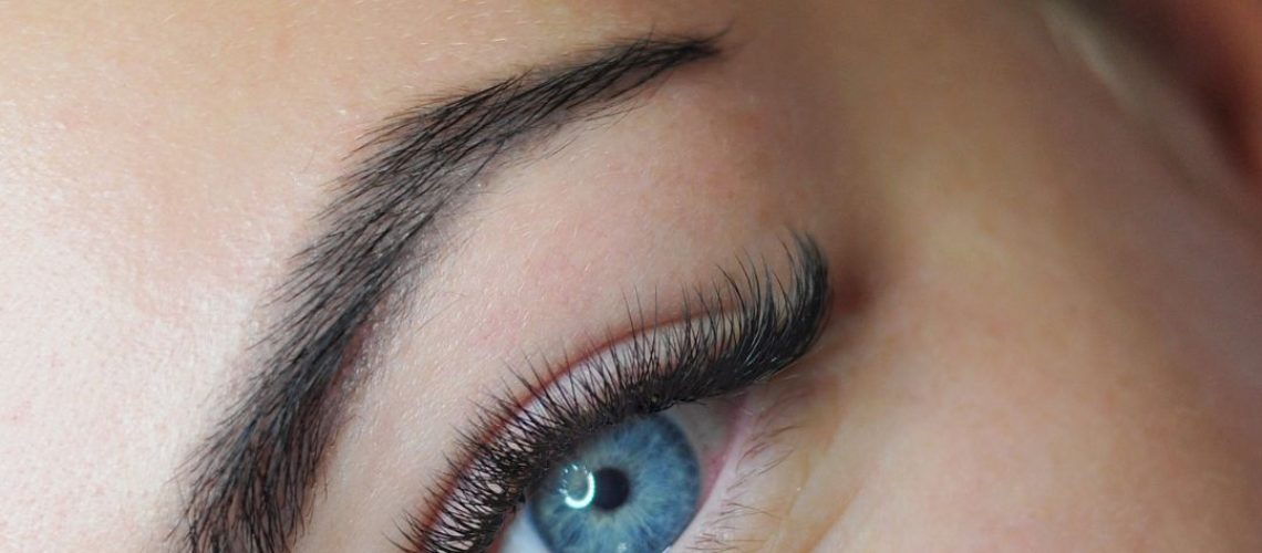 Close-up photo of fake eyelashes and a blue eye