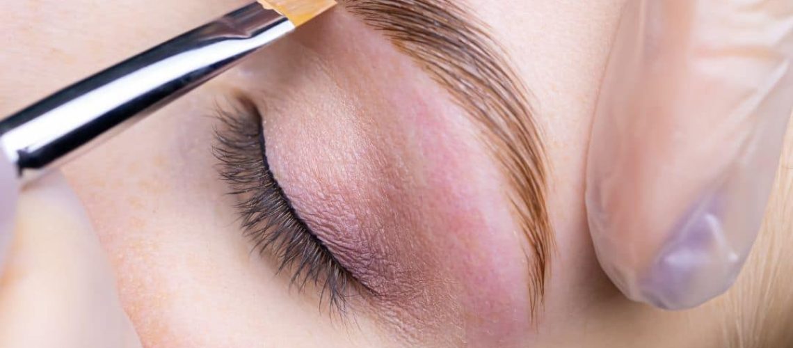 Eyebrow being marked with a brush