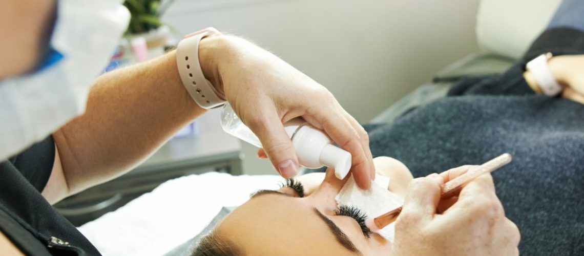 Lash tech adding lash extensions to a woman