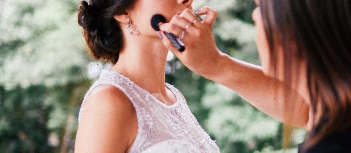 Woman having her bridal makeup done