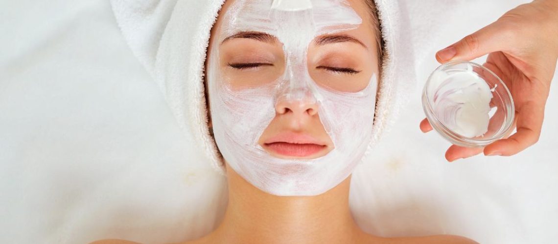 Woman having a facial mask applied