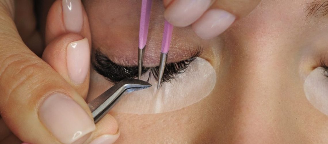 lash technician applying eyelash extensions