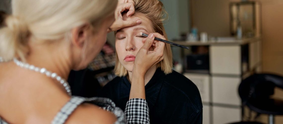 Beauty Business; Makeup artist applying makeup