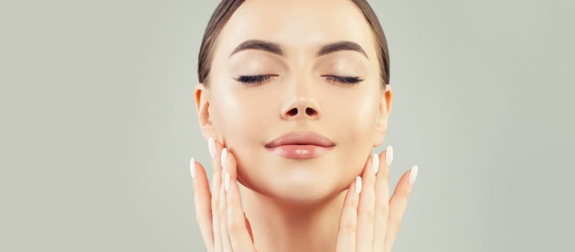 Woman applying facial treatments