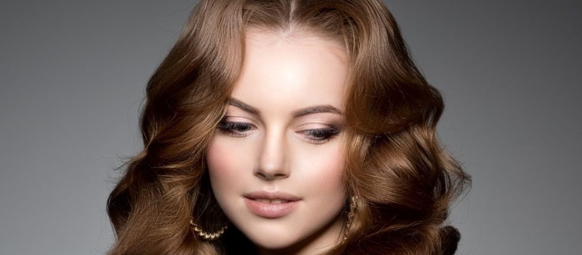 Woman with brown long curly hair