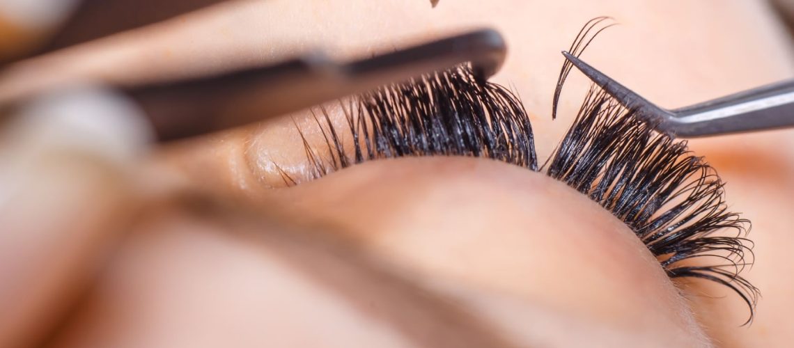 handmade fans being added to a person's eyelashes