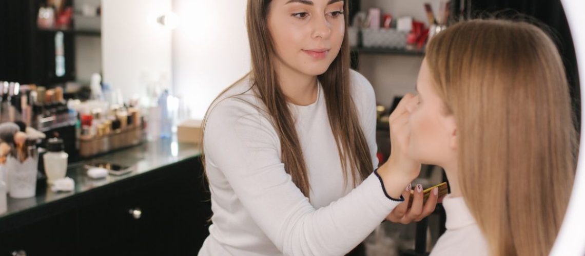 A makeup artist doing a client's makeup