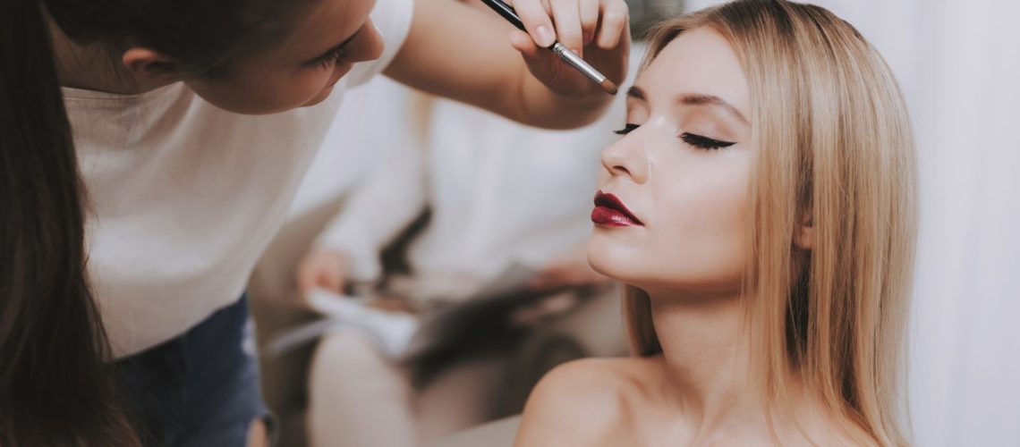 makeup artist doing a woman's makeup