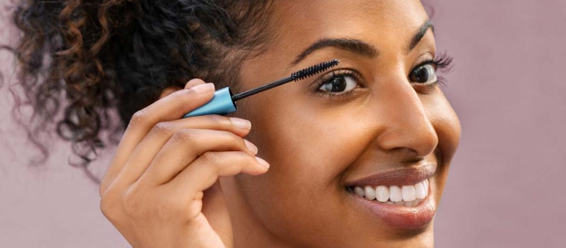 Woman applying mascara