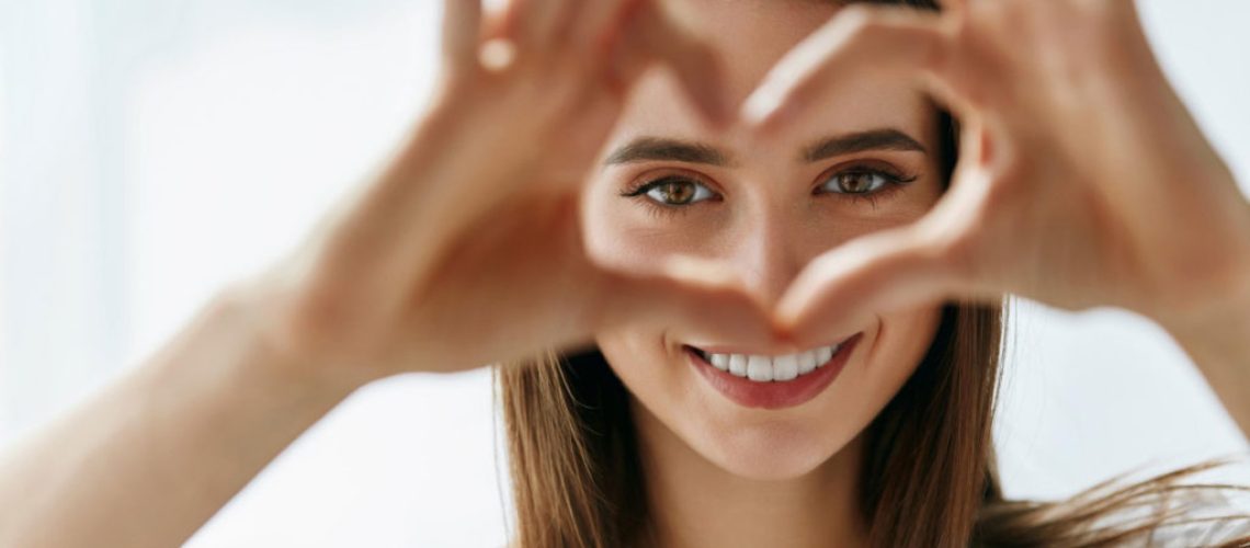 woman making a heart shape with her hands