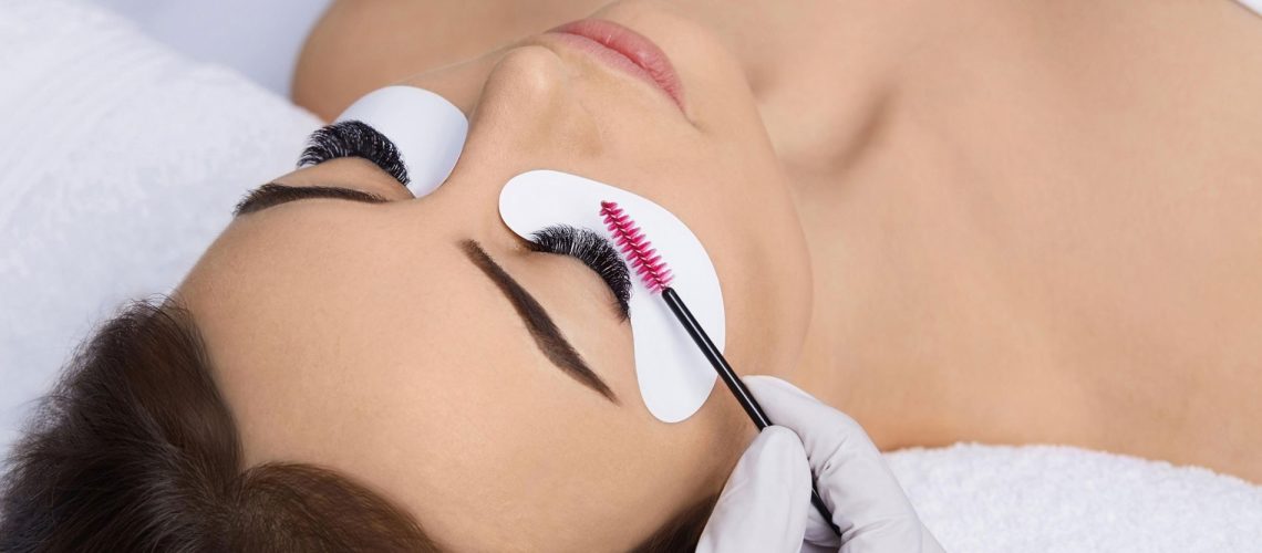 Lash tech lifting woman's eyelashes