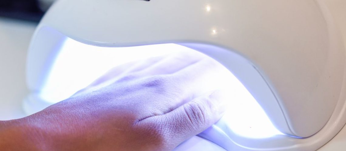 A hand in a nail lamp
