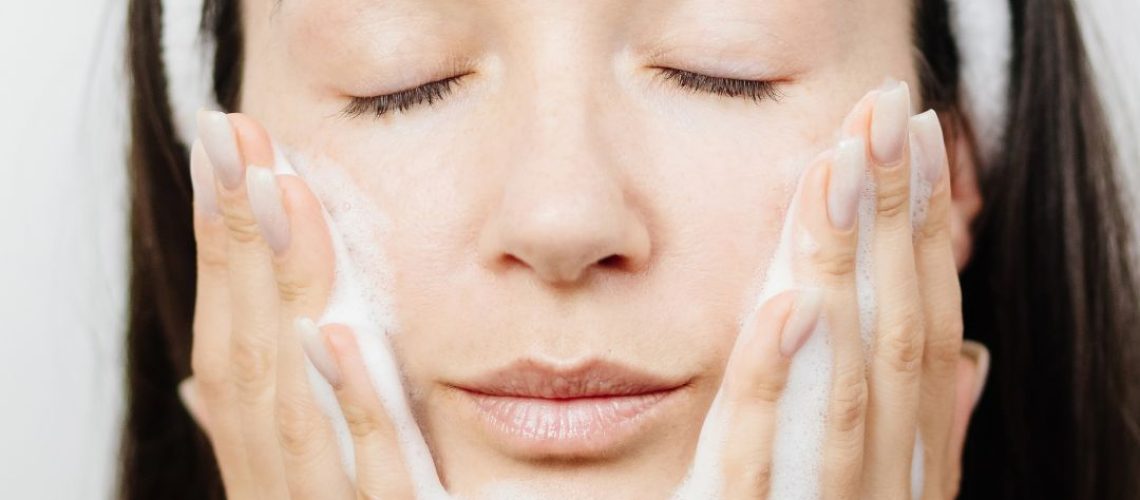 Woman cleansing her face