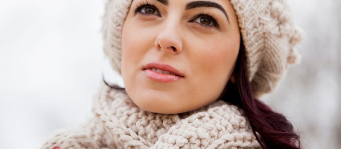 Girl wearing a scarf and beanie.