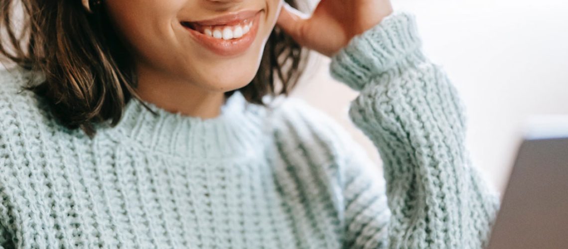 Woman smiling at her laptop