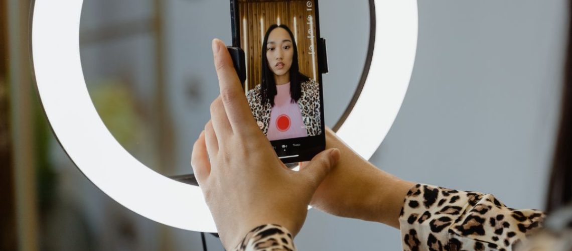 A woman holding her phone with it on self portrait
